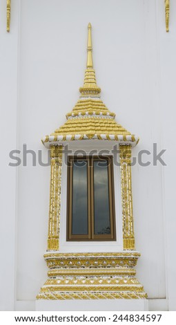 window in temple with golden frame on white background