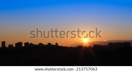 setting sun over the city and the forest