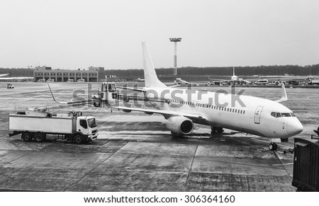 Commercial airplane parked and serviced at the airport
