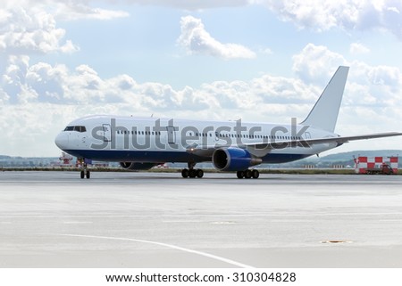 large passenger plane was taxiing for take-off in summer