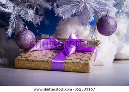 Gifts tied with ribbons under a Christmas tree