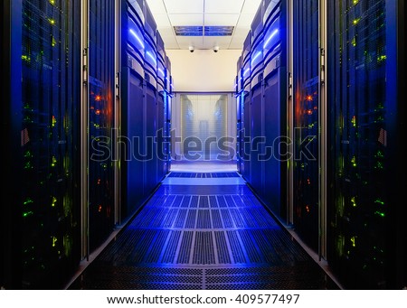 symmetrical data center room with futuristic beams and rows of equipment