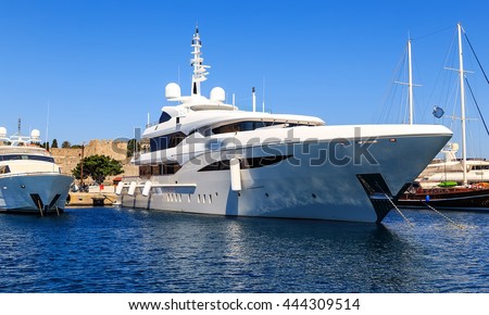 large white modern motor superyacht in the port city of Rhodes Greece