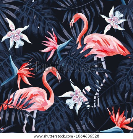 Tropical birds pink flamingo exotic flowers bird of paradise (strelitzia) dark blue palm leaves black background seamless vector pattern