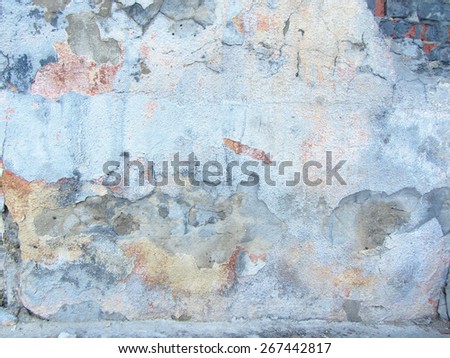 Ragged old plaster background. Grunge cracked concrete wall. The wall texture with cracked plaster and whitewash.