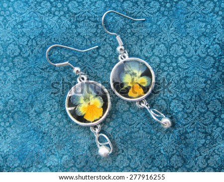 Beautiful earrings with flowers in resin. Women\'s jewelry, accessory.