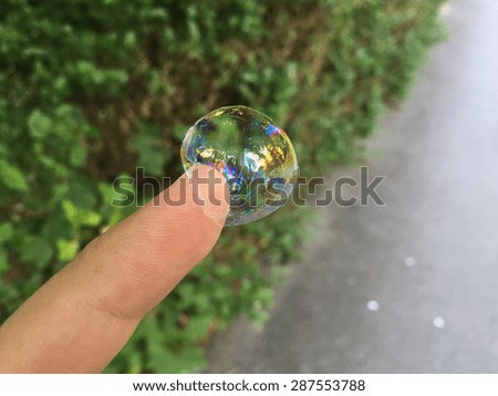 soap bubble on finger tip