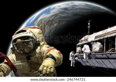 A team of Russian and United States astronauts performing work on a space station while orbiting a large, Earth-like planet. Elements of this image furnished by NASA.