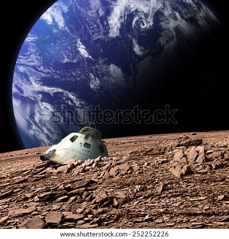 A scorched space capsule lies abandoned on a barren moon. An Earth-like planet covered in water rises in the background. - Elements of this image furnished by NASA.