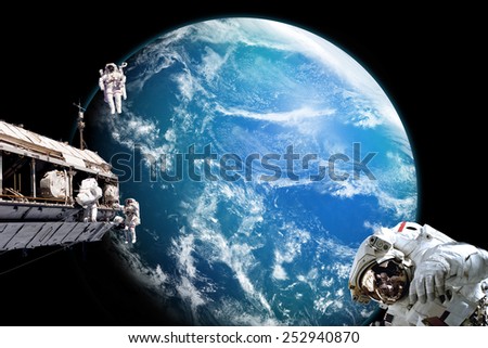 A team of astronauts perform work on a space station while orbiting above an alien water covered planet. Clouds swirl over the planet\'s ocean. -  Elements of this Image Furnished by NASA.