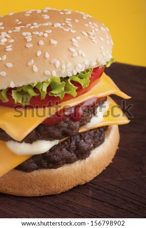 Double Cheeseburger on wooden table. This file is cleaned and retouched