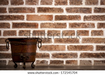 Antiques wine bucket made from brass on brick wall background
