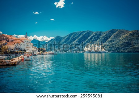 Sailfish and harbor at sunny day in Boka Kotor bay (Boka Kotorska), Montenegro, South Europe. Retro toned image.