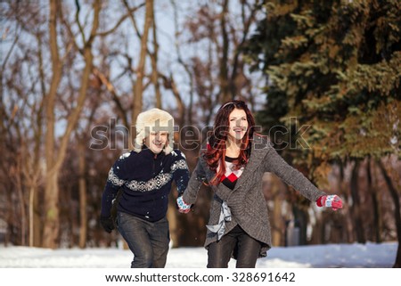 Outdoor fashion portrait of young sensual couple in cold winter weather. Love and kiss.