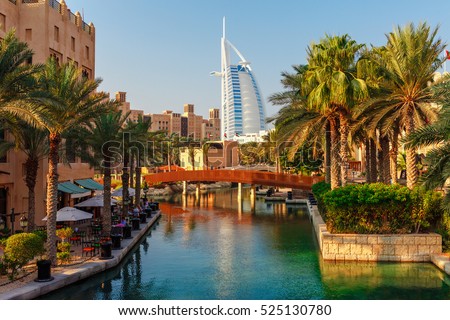 Cityscape with beautiful park with palm trees in Dubai, UAE