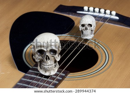 Still life art photography concept with skull and guitar
