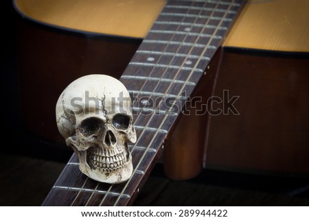 Still life art photography concept with skull and guitar