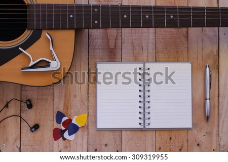 Still life art photography music and memories concept with guitar, notebook,pen,