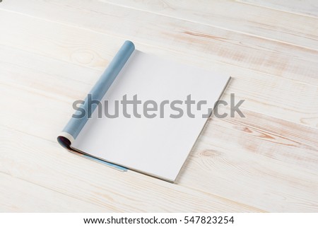 Mock-up magazine or catalog on wooden table. Blank page or notepad on wood background. Blank page or notepad for mockups or simulations.