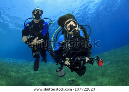 Couple having fun scuba diving together