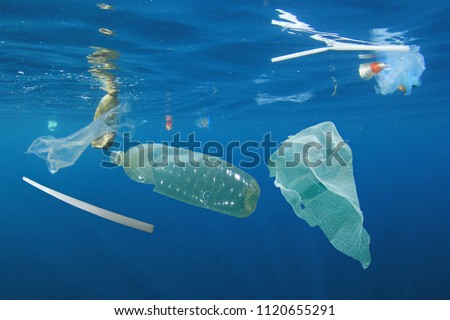 Plastic ocean pollution. Underwater bags, bottles, cups, straws