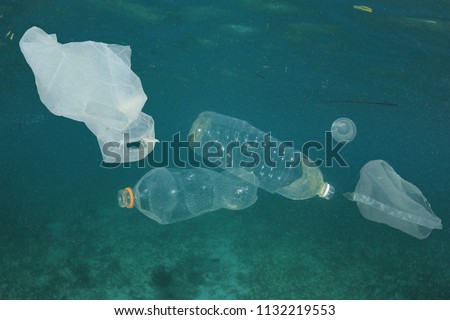 Plastic bags and bottles pollution underwater in ocean