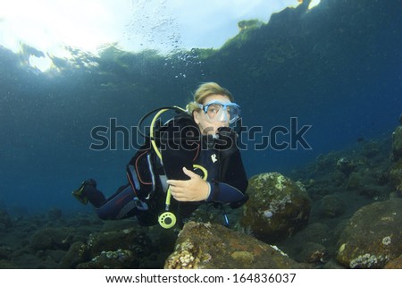 Blonde woman Scuba Diver underwater