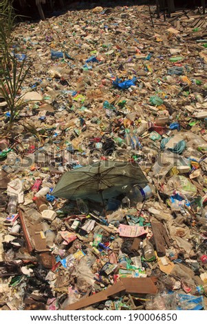 KOTA KINABALU, MALAYSIA - APRIL 26 2014: Plastic rubbish pollution in poor slum. Photo showing pollution problem of garbage thrown out with no proper trash collection or recycling.