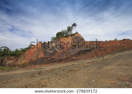 Deforestation: Scarred earth where tropical rain forest has been destroyed by human development in Borneo, Malaysia