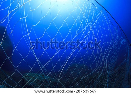 Abandoned fishing net underwater causes environmental problem and pollution