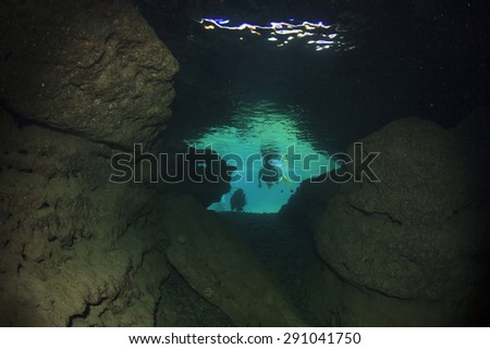 Underwater cave and scuba divers