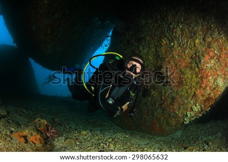 Female Scuba Diver exploring underwater reef and caves