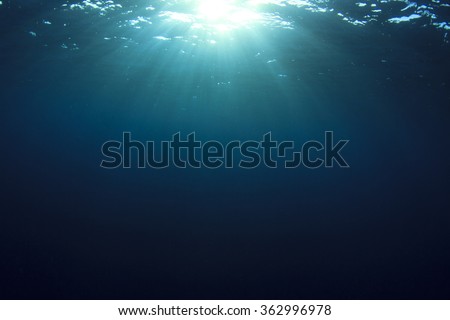 Underwater blue ocean background and sun