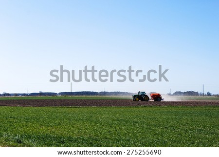 OLAND, SWEDEN - APRIL 21: Springtime with farmers tractor work at a field at the swedish island Oland. Photo taken on April 21 2015 at the island Oland in Sweden.