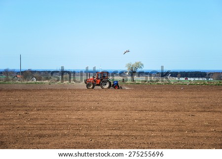 OLAND, SWEDEN - APRIL 21: Farmer seeding corn with his tractor at springtime at the swedish island Oland. Photo taken on April 21 2015 at the island Oland in Sweden.