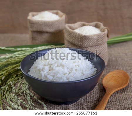 Thai fragrant jasmine rice in a bowl, with a garnish of Thai basil which is in flower.