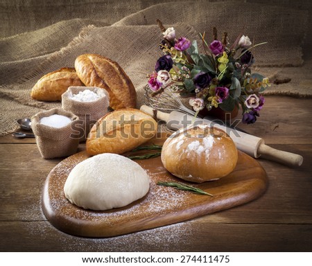 Making bread on table on wooden background