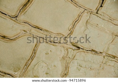 Brown rock with erosion cutting patterns into it