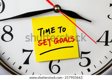 time to set goals on post-it stuck to a wall clock