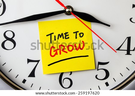 time to grow on post-it stuck to a wall clock