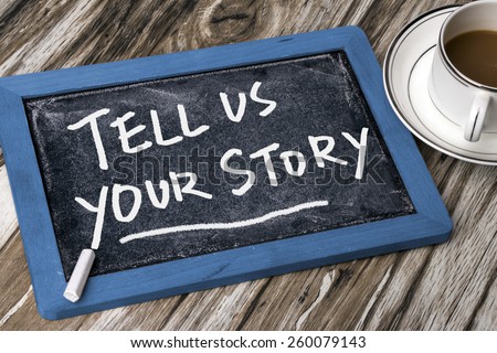 tell us your story handwritten on blackboard