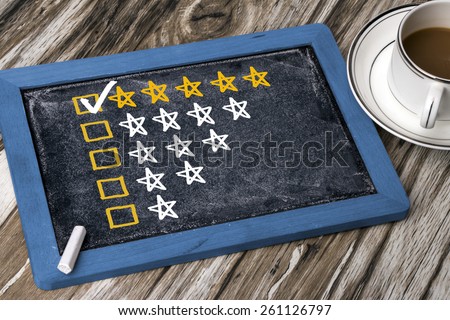 five star rating concept on blackboard