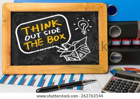 think outside the box concept hand drawing on blackboard