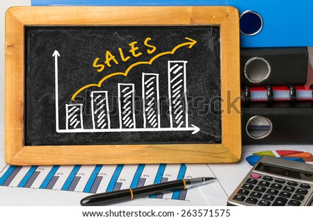 sales graph concept hand drawing on blackboard