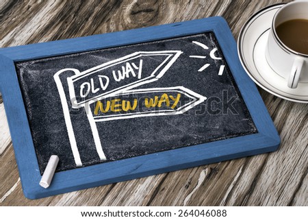 new way or old way concept signpost hand drawing on blackboard