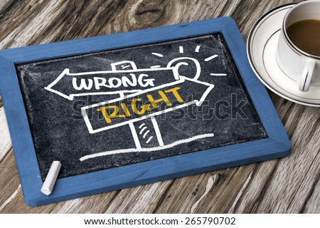 right or wrong signpost concept hand drawing on blackboard