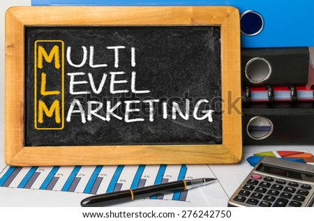 MLM concept:multi level marketing handwritten on blackboard