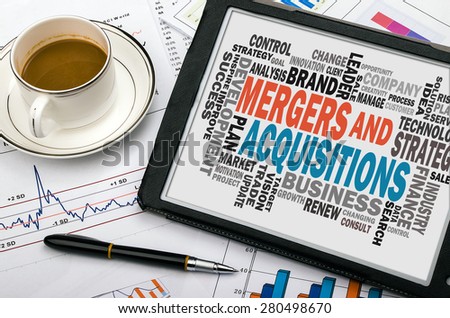 mergers and acquisitions concept with business word cloud handwritten on tablet pc
