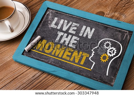 live in the moment concept on blackboard