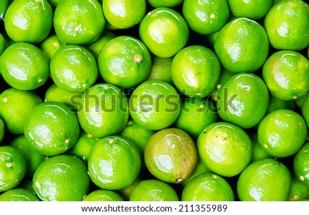 Fresh green lemons background.